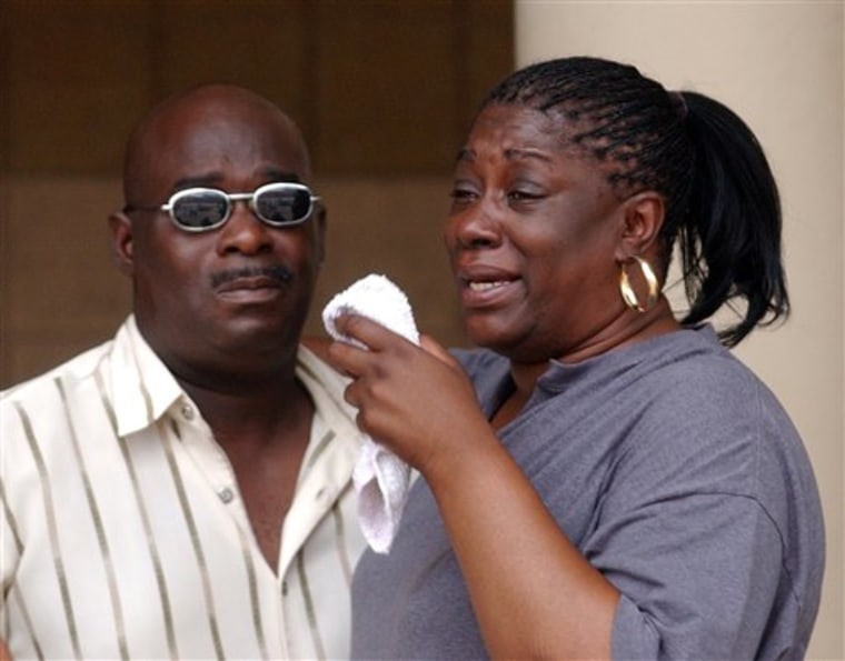 Tracy Emery, right, and her husband, name unavailable, react outside the courthouse after their daughter, 23-year-old Torrie Emery's arraignment in Pontiac, Mich. on Friday July 23, 2010. Torrie Emery was charged with second-degree murder, assault and child abuse in a fatal car crash stemming from a dispute on the social networking site Facebook. Police say the woman had her 3-year-old daughter in the car Wednesday afternoon when she rammed a car being driven by Alesha Abernathy of Pontiac. Police said Abernathy's car hit a dump truck while being chased. (AP Photo/The Oakland Press, Vaughn Gurganian) MANDATORY CREDIT